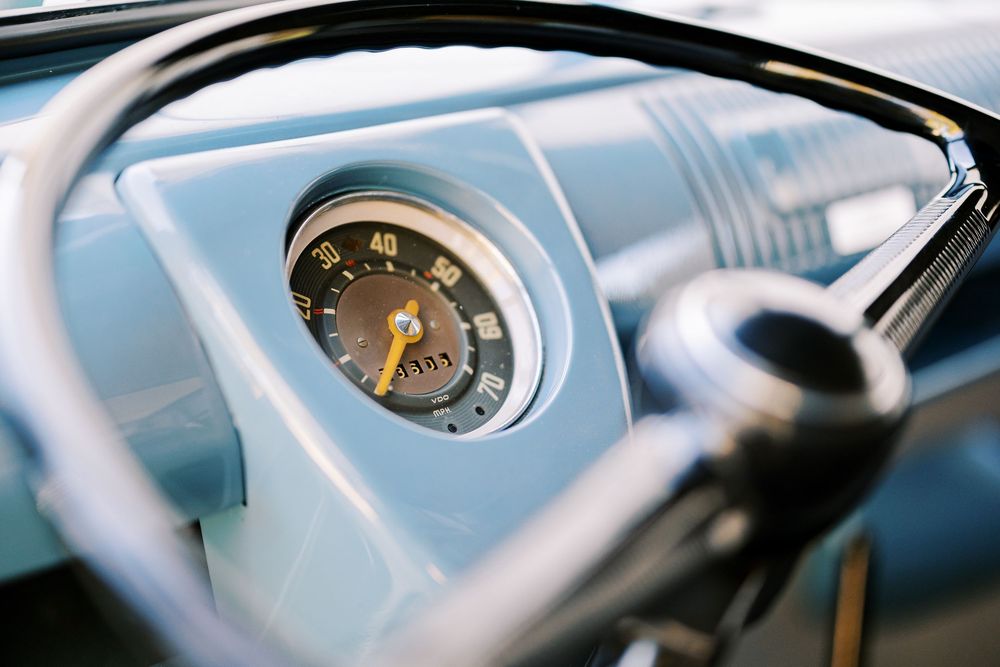Detail shots of vintage VW dashboard gauges and controls in chrome and black.