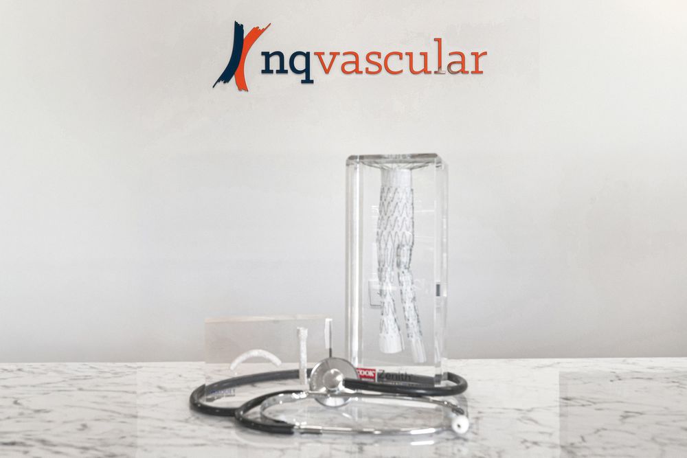 Medical equipment and vials arranged in a row against a white background for healthcare industry photography.