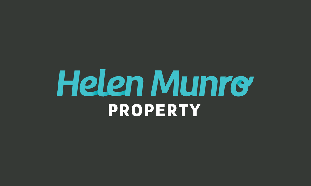 A teal and white real estate property sign with modern typography against a dark background.