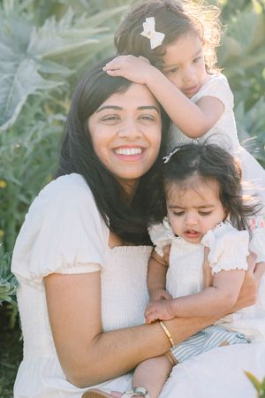A heartwarming family moment captured in a sunny garden setting.