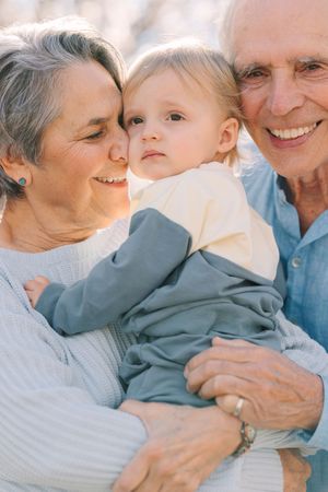 Close-up sequence of tender family moments and embraces in soft lighting.