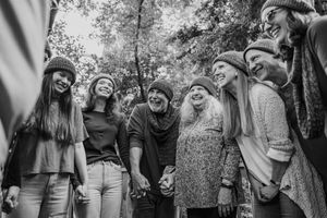 A collection of black and white photos showing people walking and enjoying nature outdoors together.