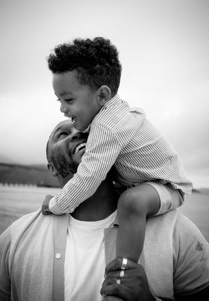 Black and white photo series showing tender moments between a parent and small child.