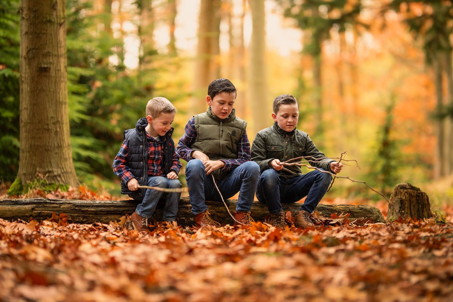 Boys playing in the woods during a woodland autumn photoshoot in Berkshire.