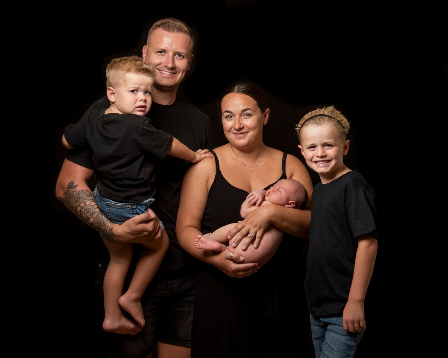Family low-key studio portrait.
