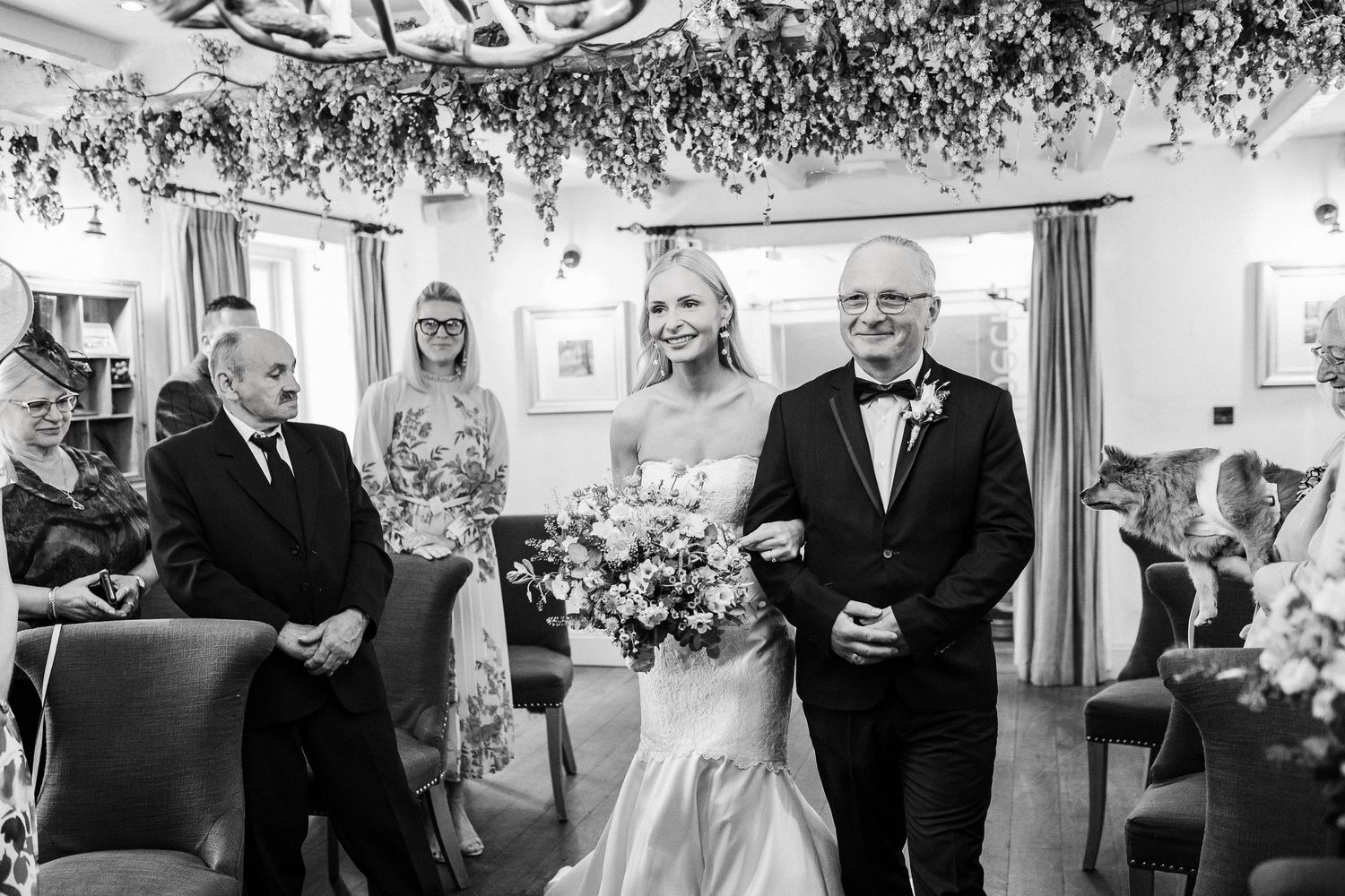 A series of black and white wedding reception photos showing guests mingling and celebrating.