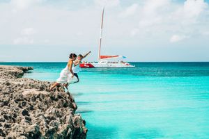 Aerial panoramic view of crystal clear turquoise waters and rocky coastline in the Caribbean Sea.