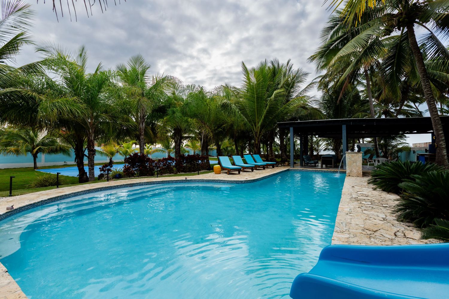 Pool, tennis court, patio and barbecue area. Beach house in Vega Baja, Puerto Rico.