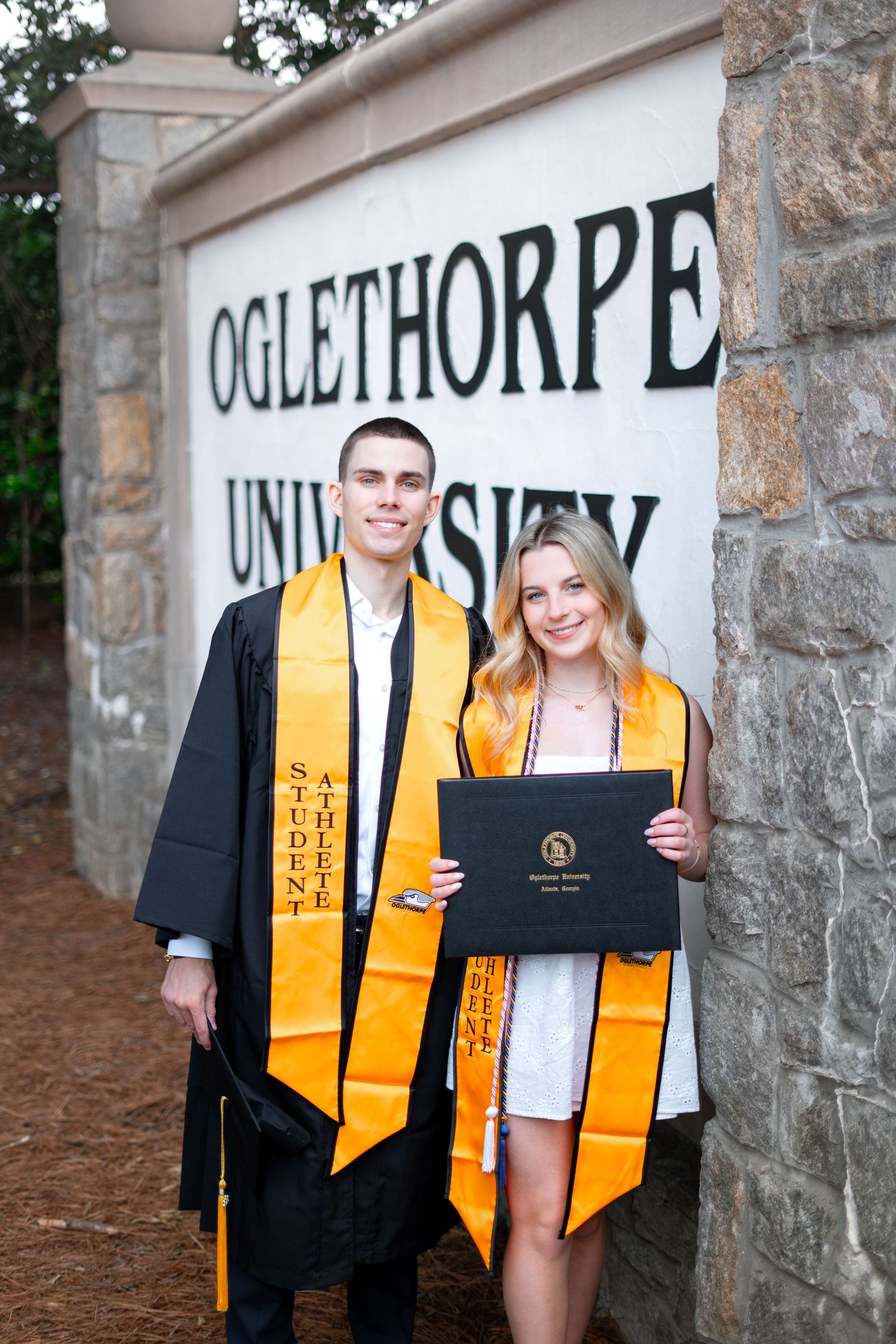 Oglethorpe graduation photos at the OU sign in Brookhaven, Atlanta
