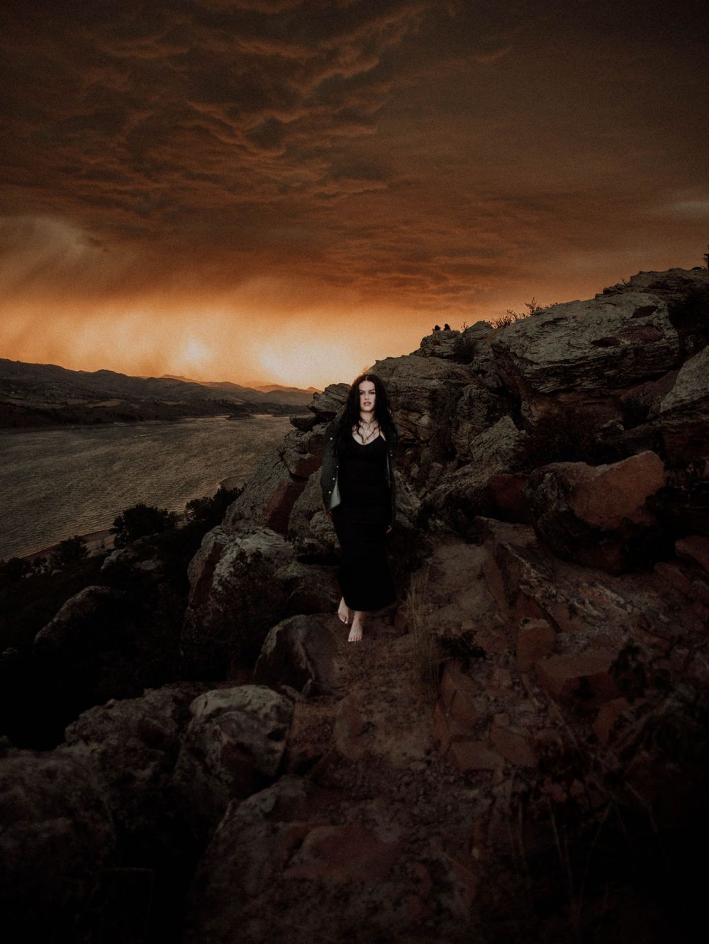 Woman poses in front of dramatic, cinematic sky for portrait and modeling photos in Fort Collins, Colorado