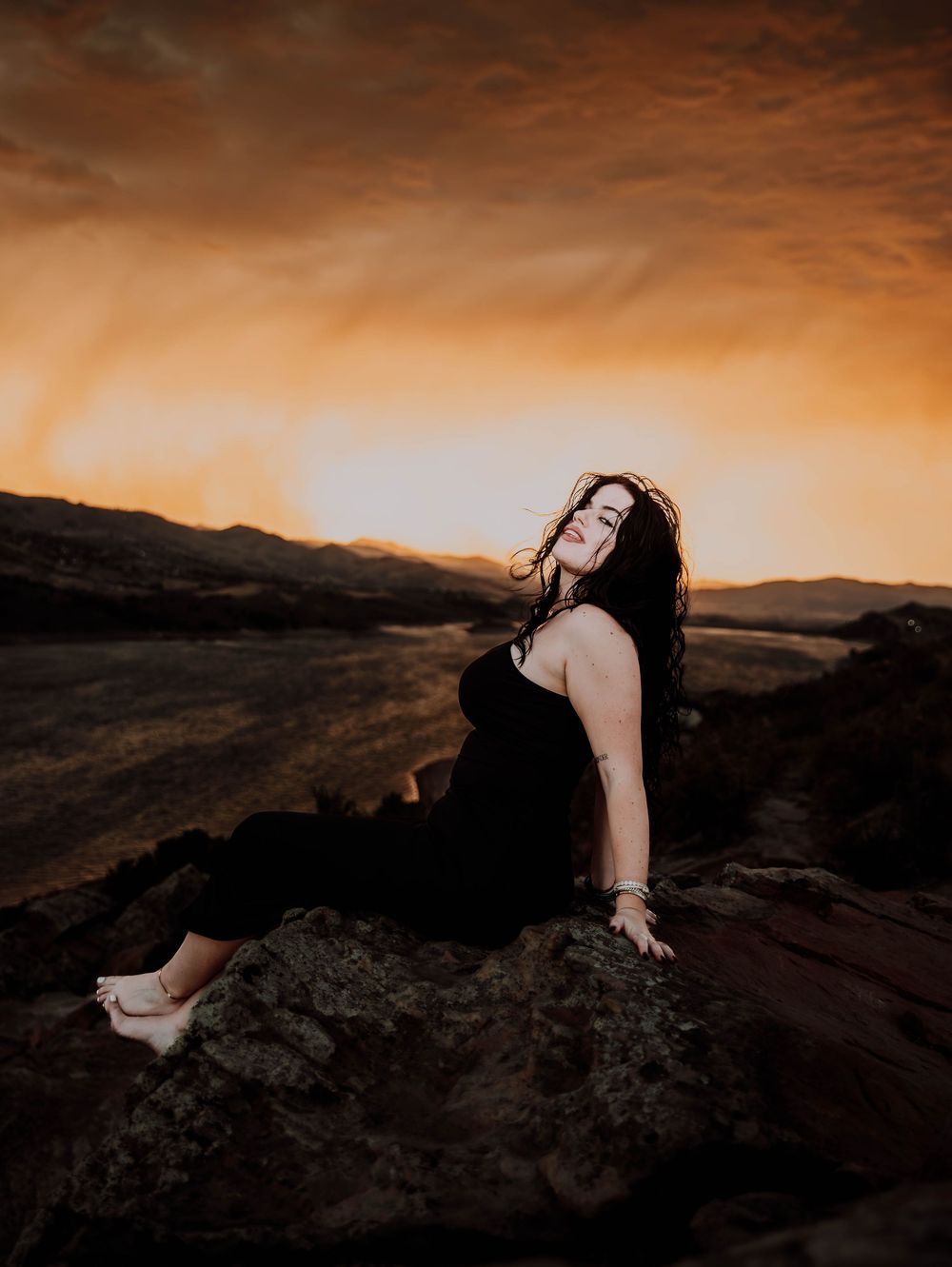 Woman poses in front of dramatic, cinematic sky for portrait and modeling photos in Fort Collins, Colorado
