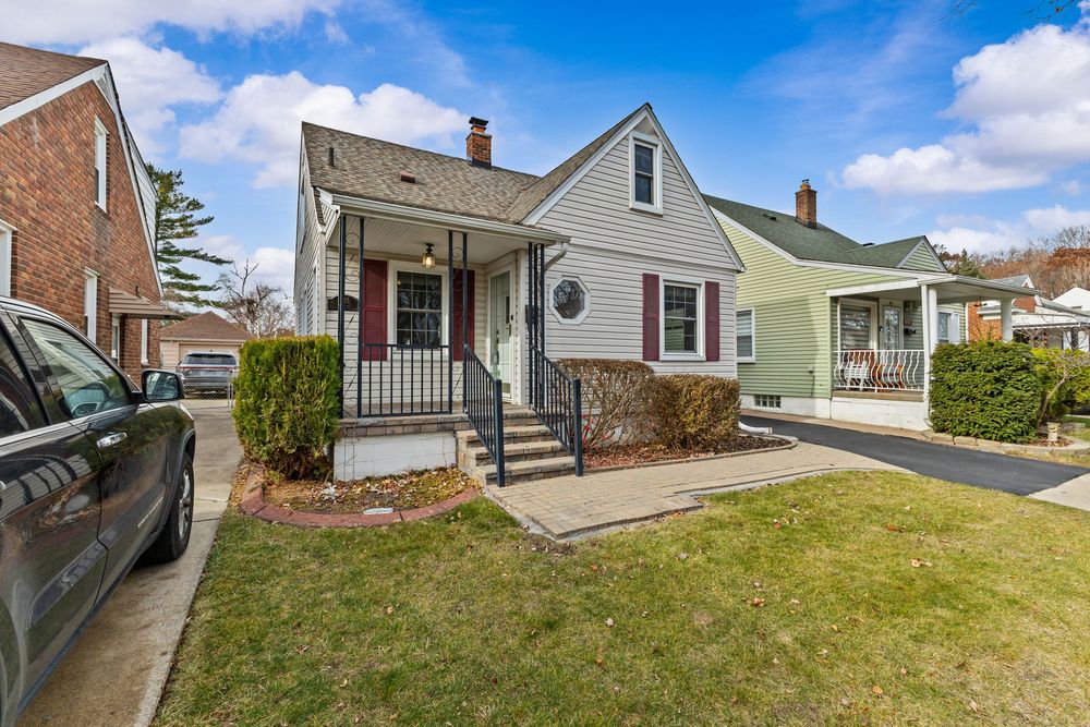 Cape Cod style home with covered porch and brick paver walkway on Westland Street Dearborn Michigan