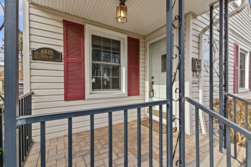 Cape Cod style home with covered porch and brick paver walkway on Westland Street Dearborn Michigan
