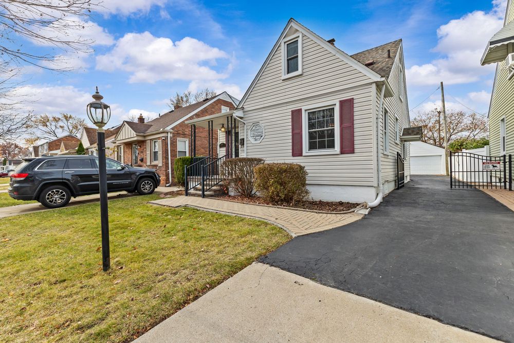 Cape Cod style home with covered porch and brick paver walkway on Westland Street Dearborn Michigan