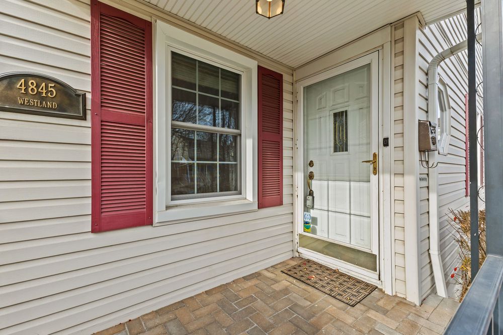 Cape Cod style home with covered porch and brick paver walkway on Westland Street Dearborn Michigan