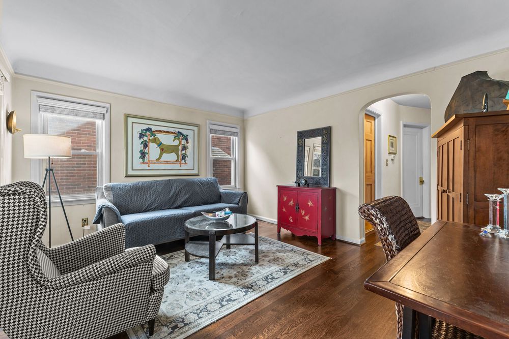 Living room with dark hardwood floors and arched doorway in Dearborn Michigan Cape Cod
