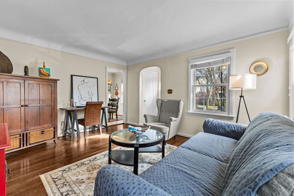 Living room with dark hardwood floors and arched doorway in Dearborn Michigan Cape Cod