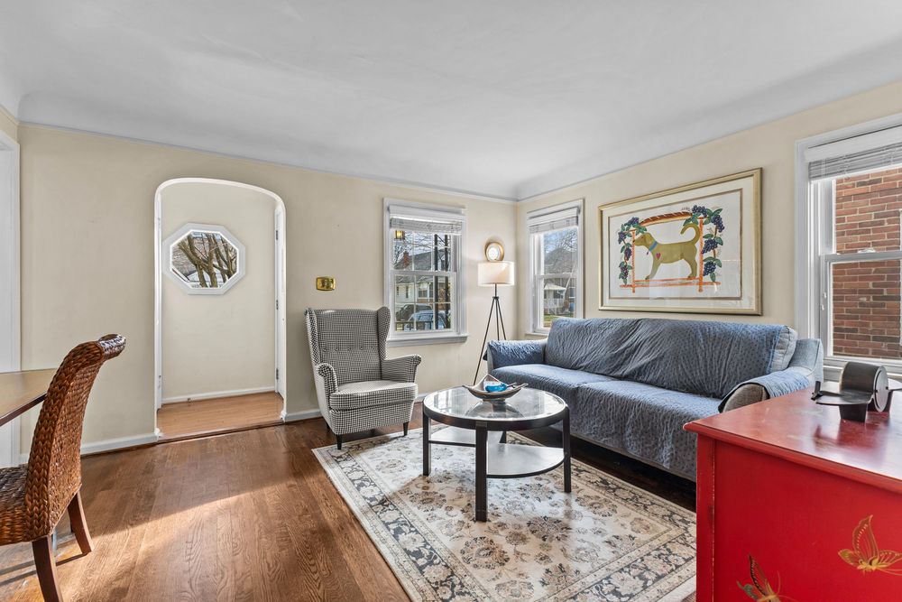 Living room with dark hardwood floors and arched doorway in Dearborn Michigan Cape Cod
