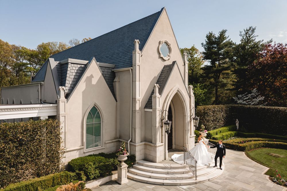 Bride and groom arrive at a stunning white Gothic chapel on their wedding day.
