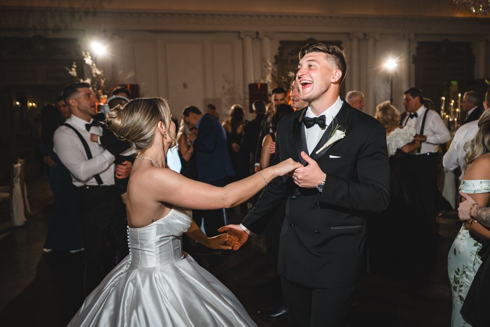 Bride and groom share a joyful dance together at their wedding reception.