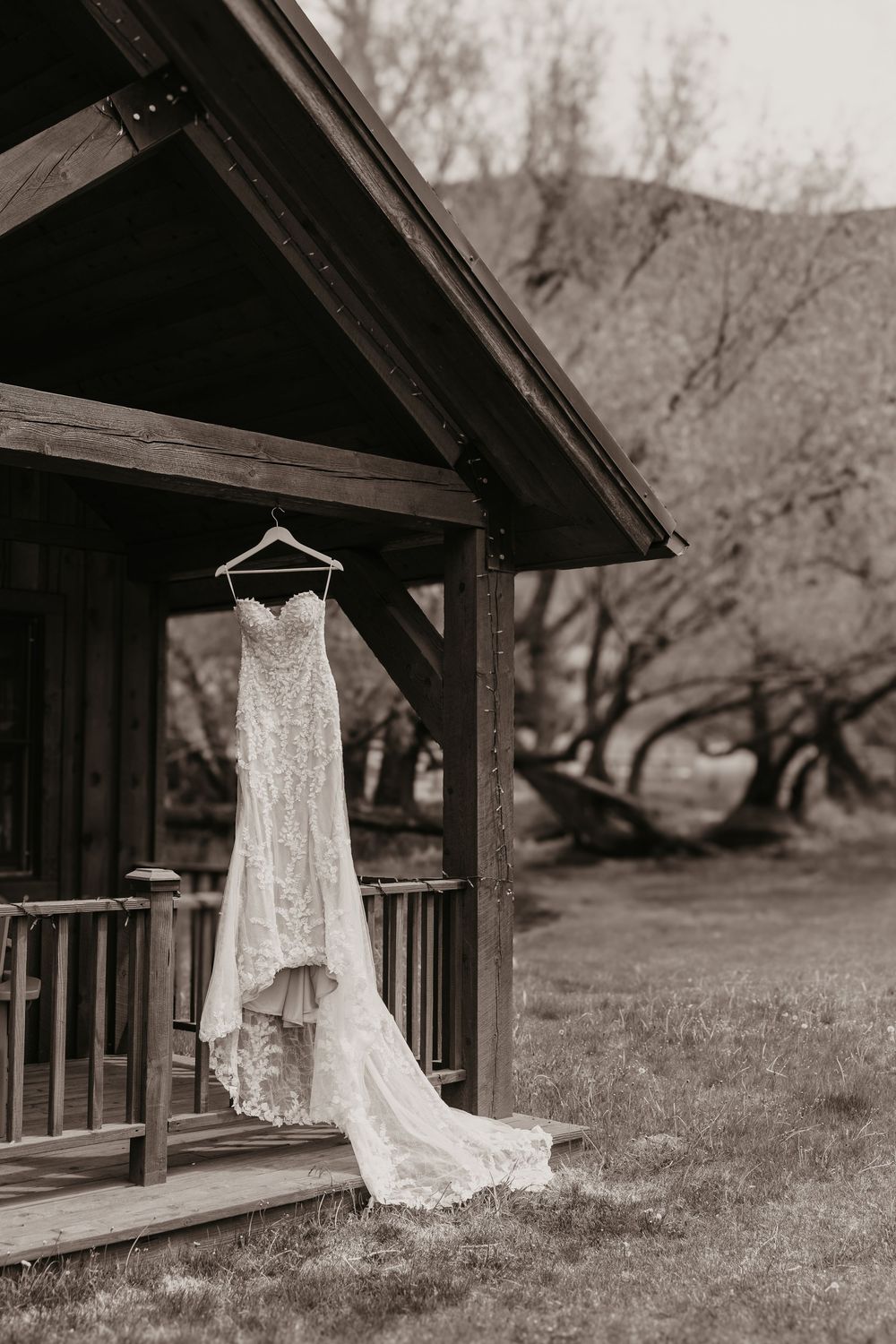 Chico Hot Springs Cabin has Wester Bride Wedding Dress hanging on the outside of the Cabin. Chico Wedding and Elopement Photographer