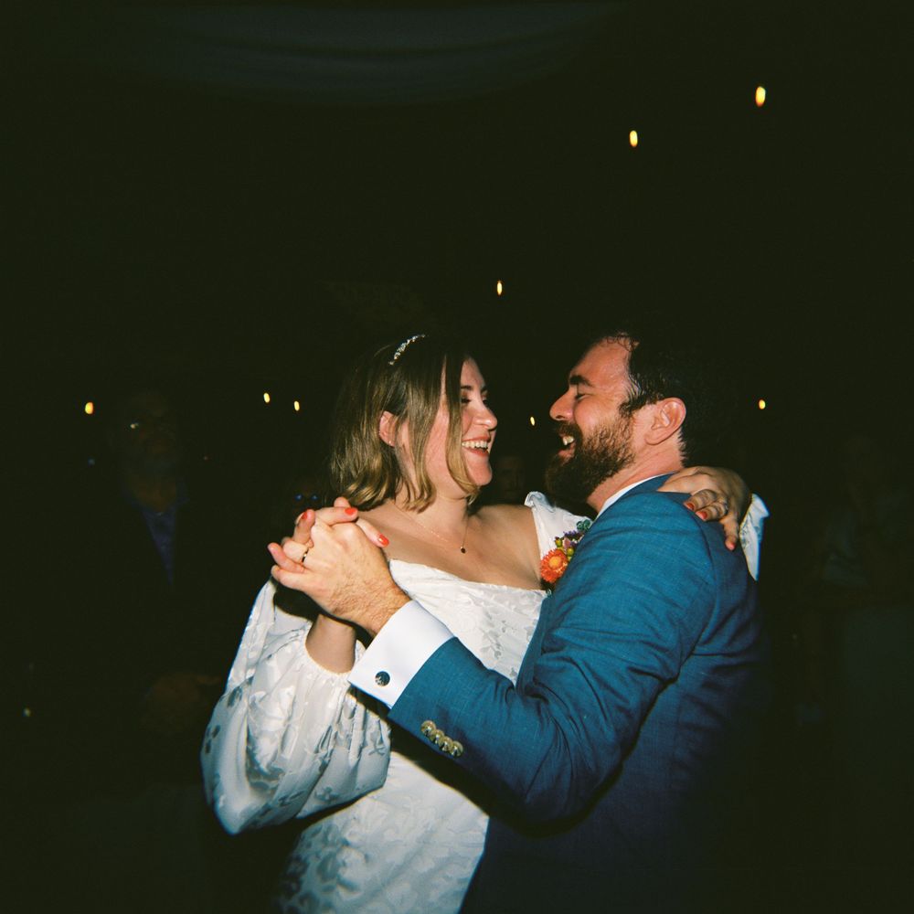 Medium format film photo with flash of the couple during their first dance at their wedding reception in the summer in southern Maine.