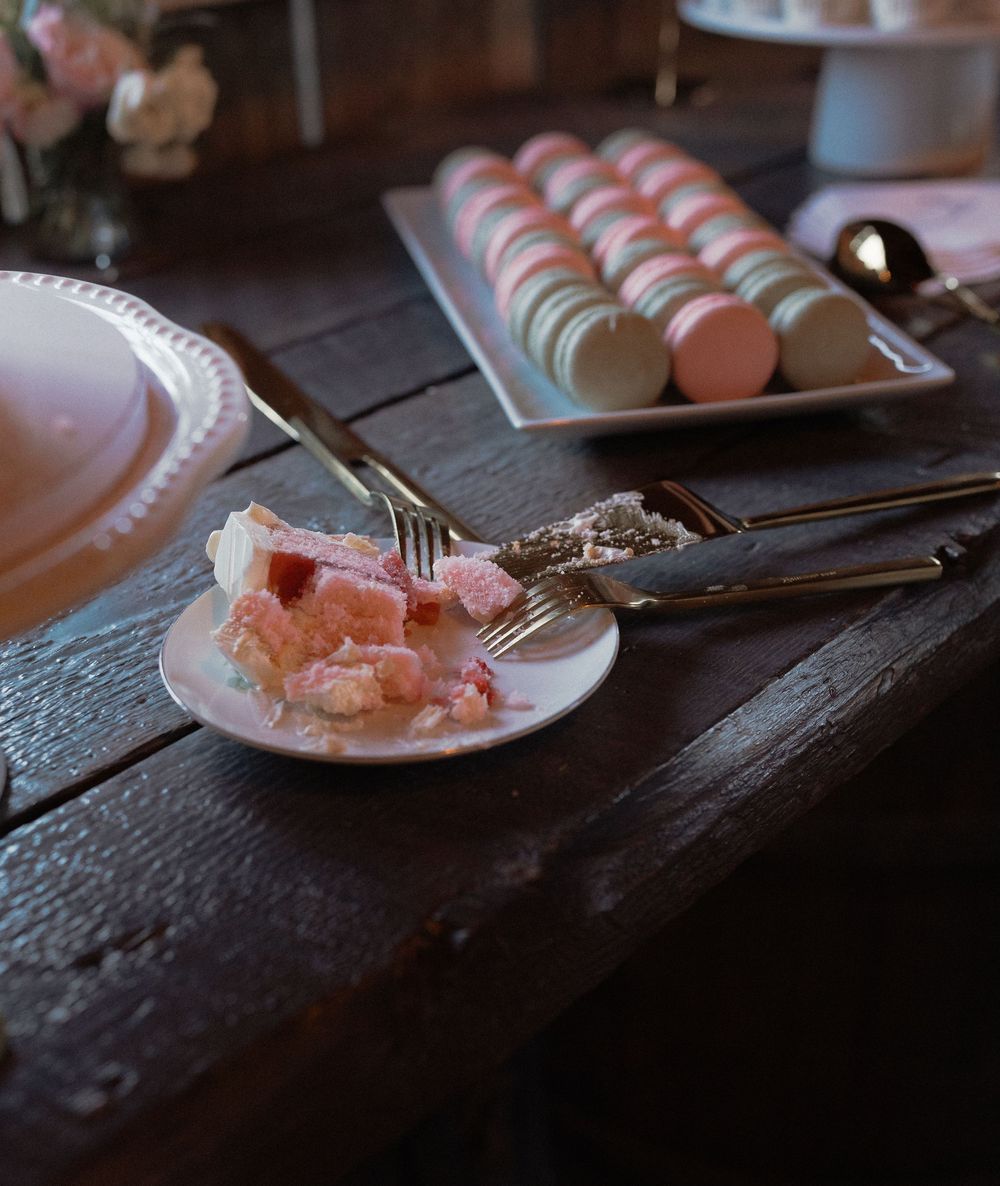 Raw sashimi pieces are elegantly plated on rustic wooden surfaces in dim lighting.