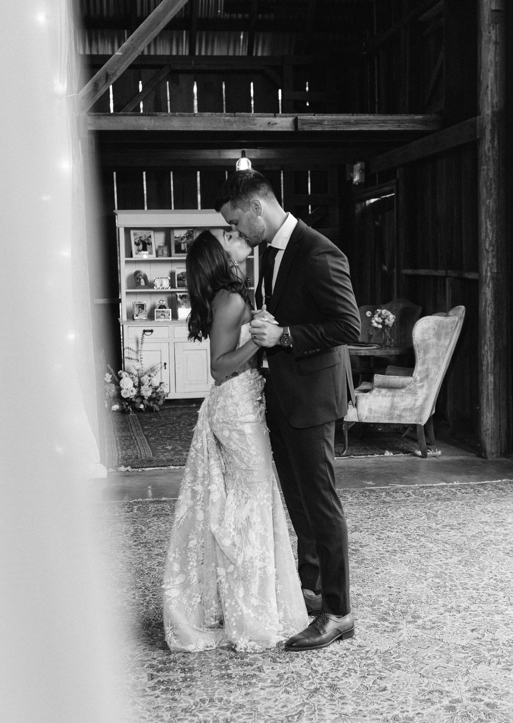 Romantic first dance sequence between newlyweds in a rustic barn venue.