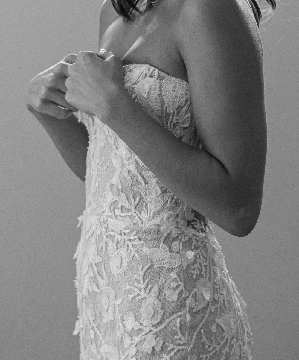 A series of black and white fashion photographs showing the intricate details of a white lace wedding dress.