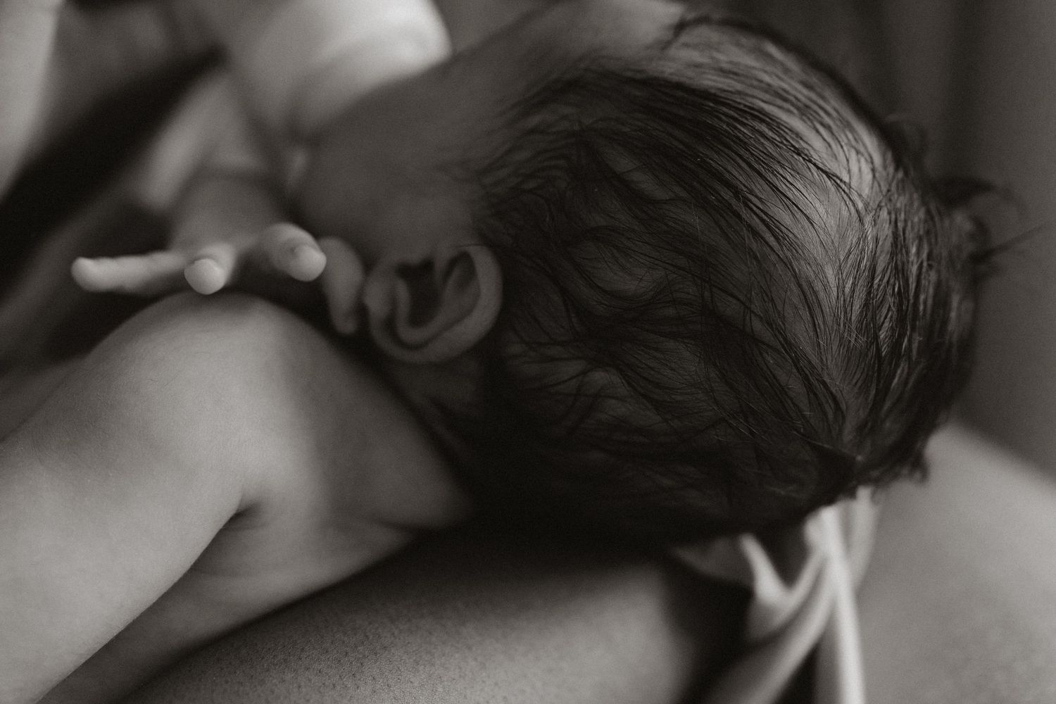 A series of intimate black and white close-up photographs showing tender moments.