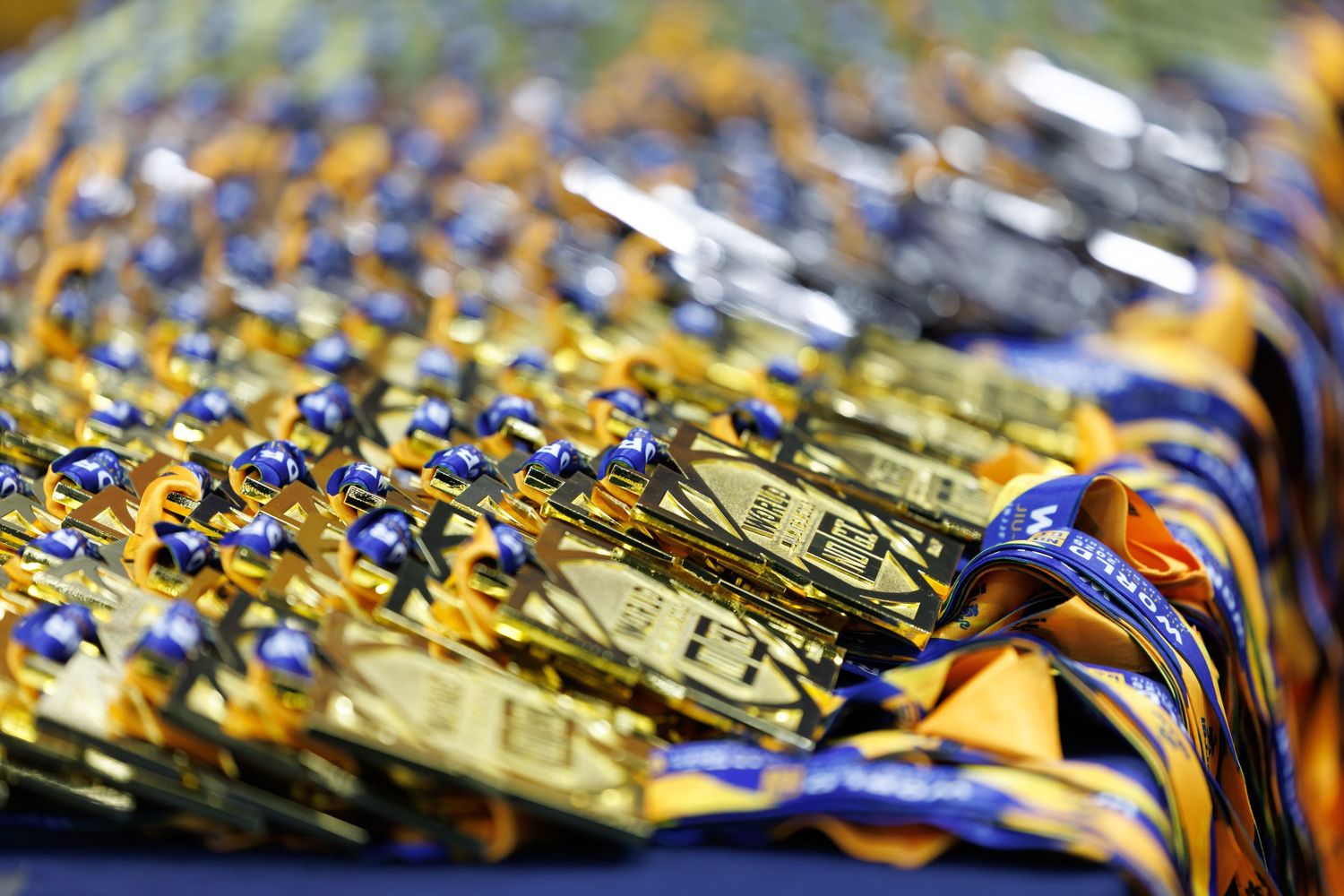 Close-up of decorative gold and blue medals arranged in a row.