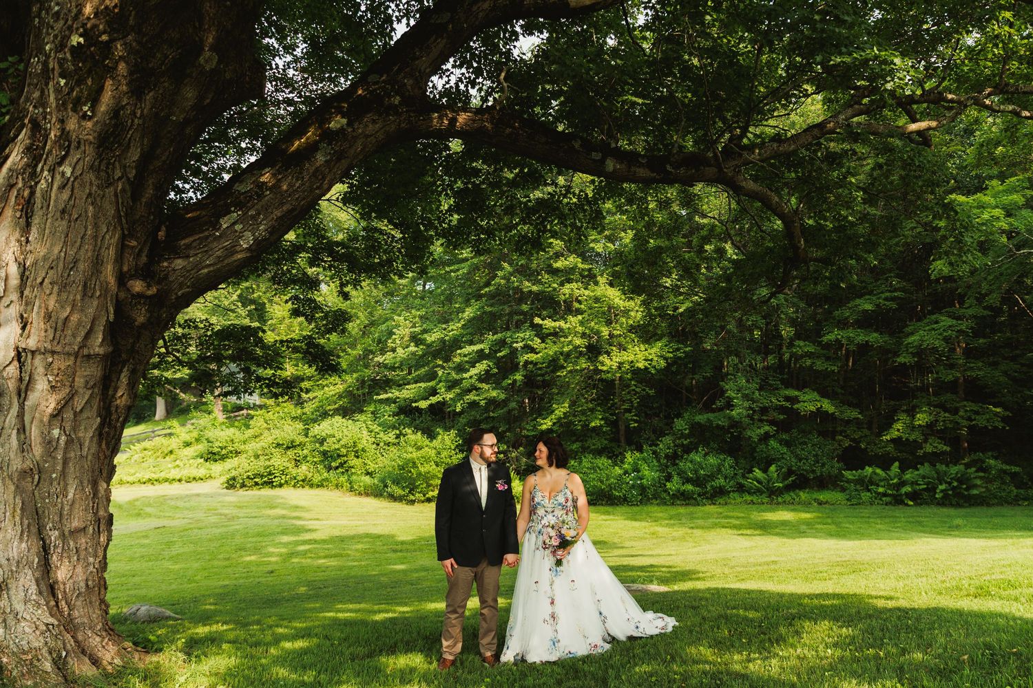 Outdoor wedding photography session in a scenic garden setting with natural greenery.