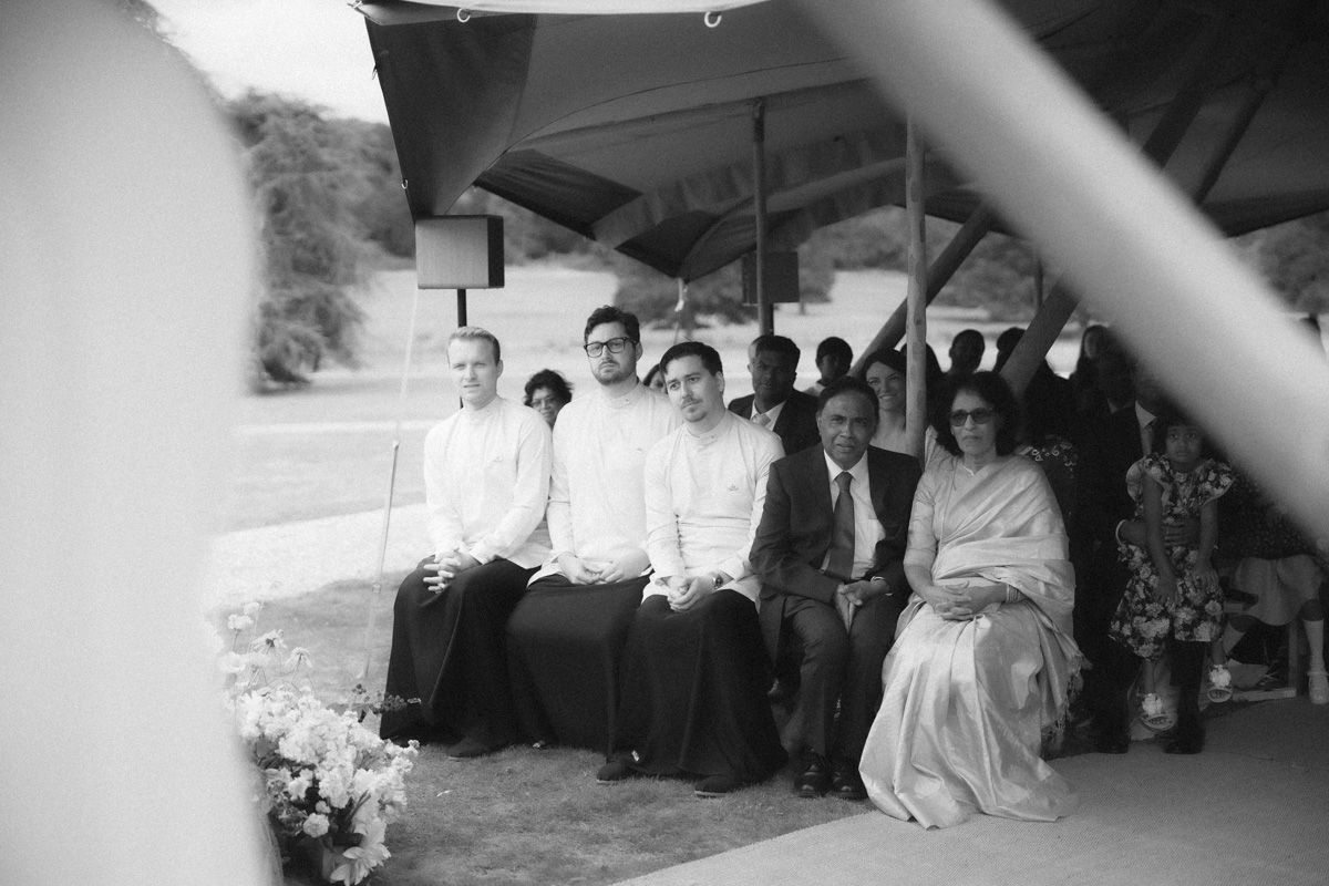 A black and white photo montage shows several candid moments from what appears to be a wedding reception celebration.