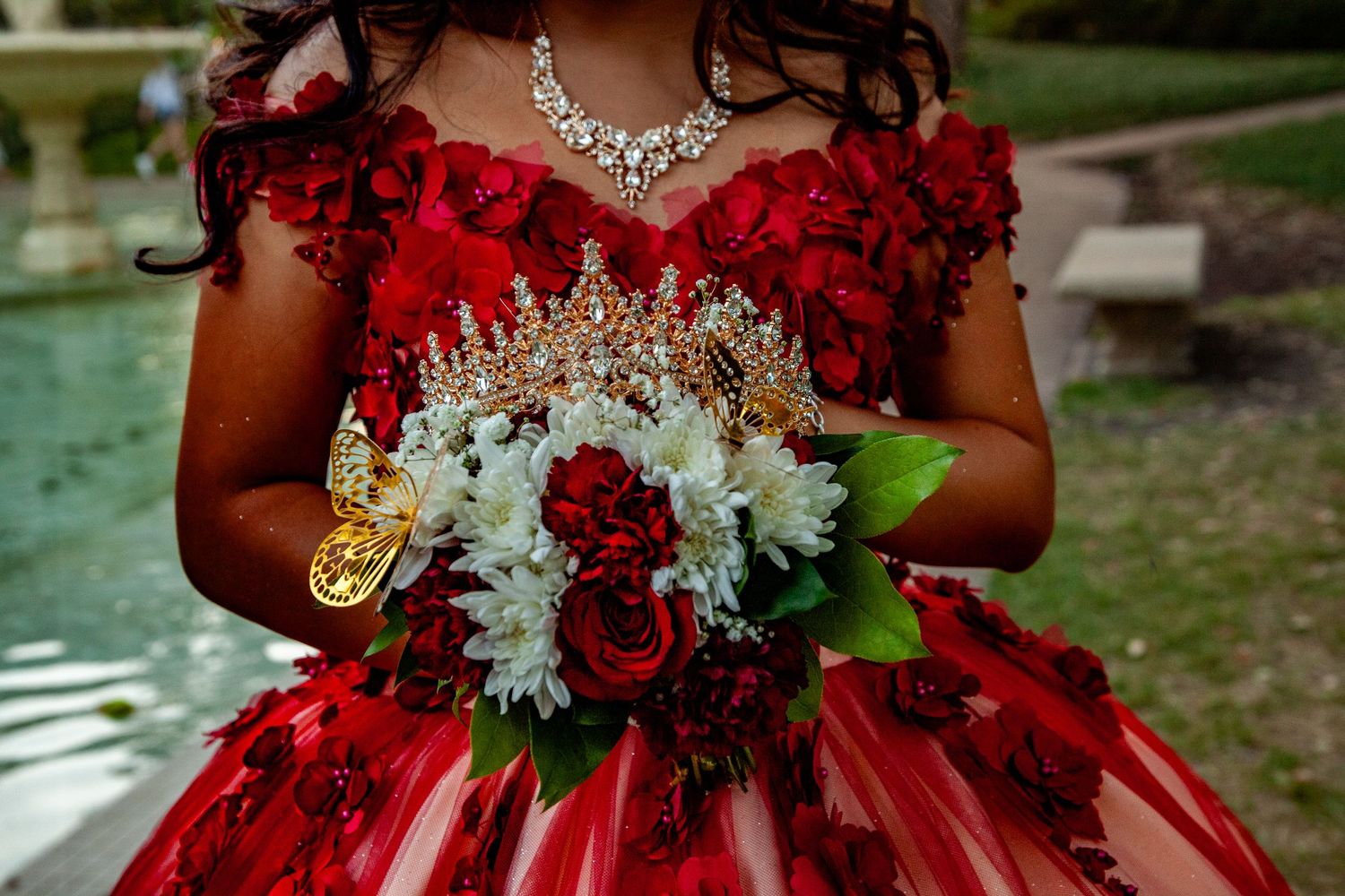 A stunning red and white wedding bouquet with roses and lilies arranged in an elegant cascading style.