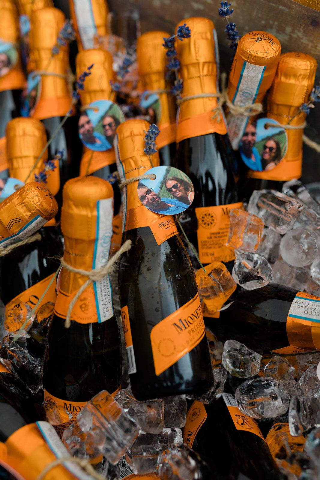 Multiple orange Veuve Clicquot champagne bottles nestled in ice at a luxury bar or event setting.