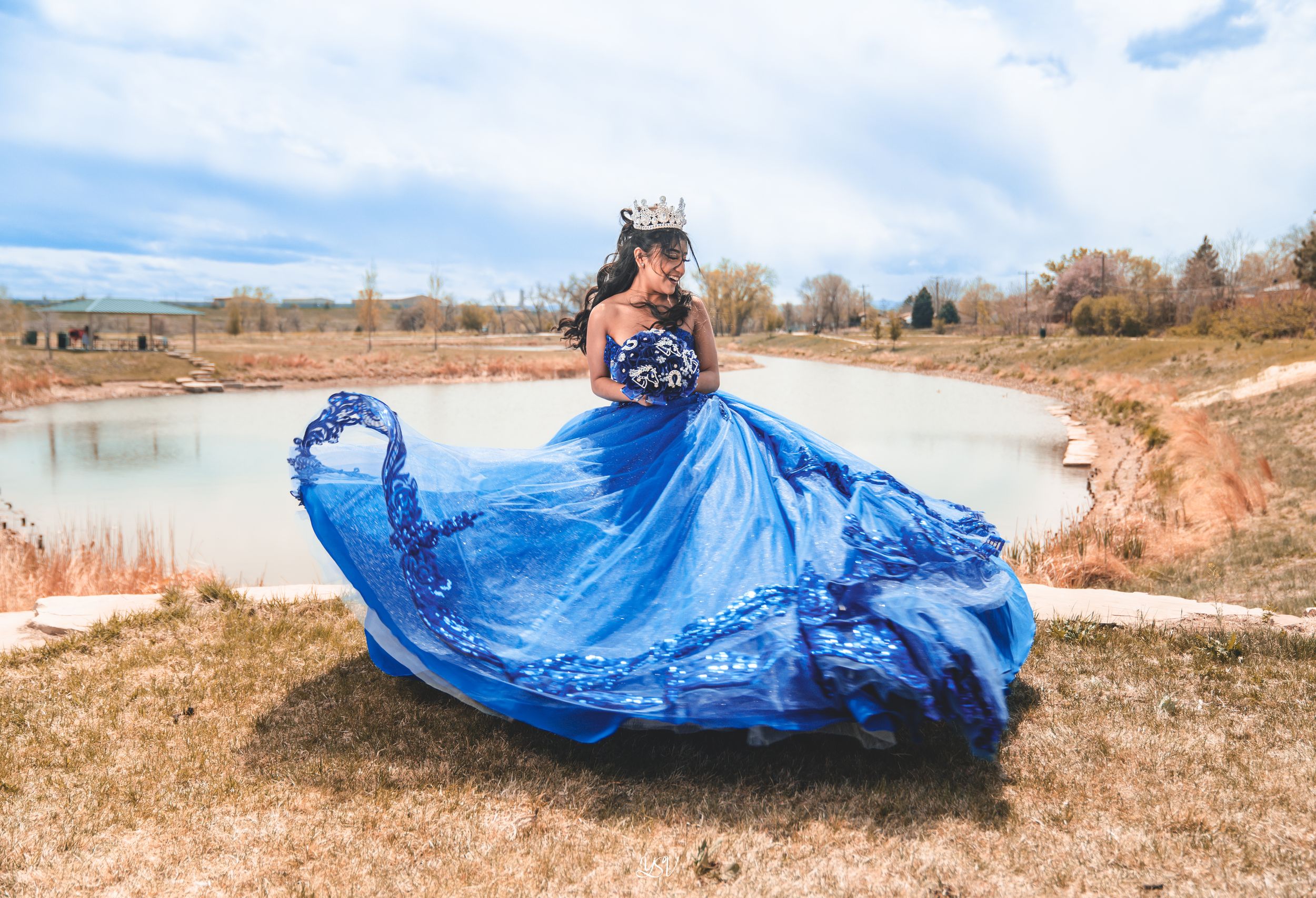 A sequence of images showing a blue tarp being blown and carried by strong winds across a dry grassy field.
