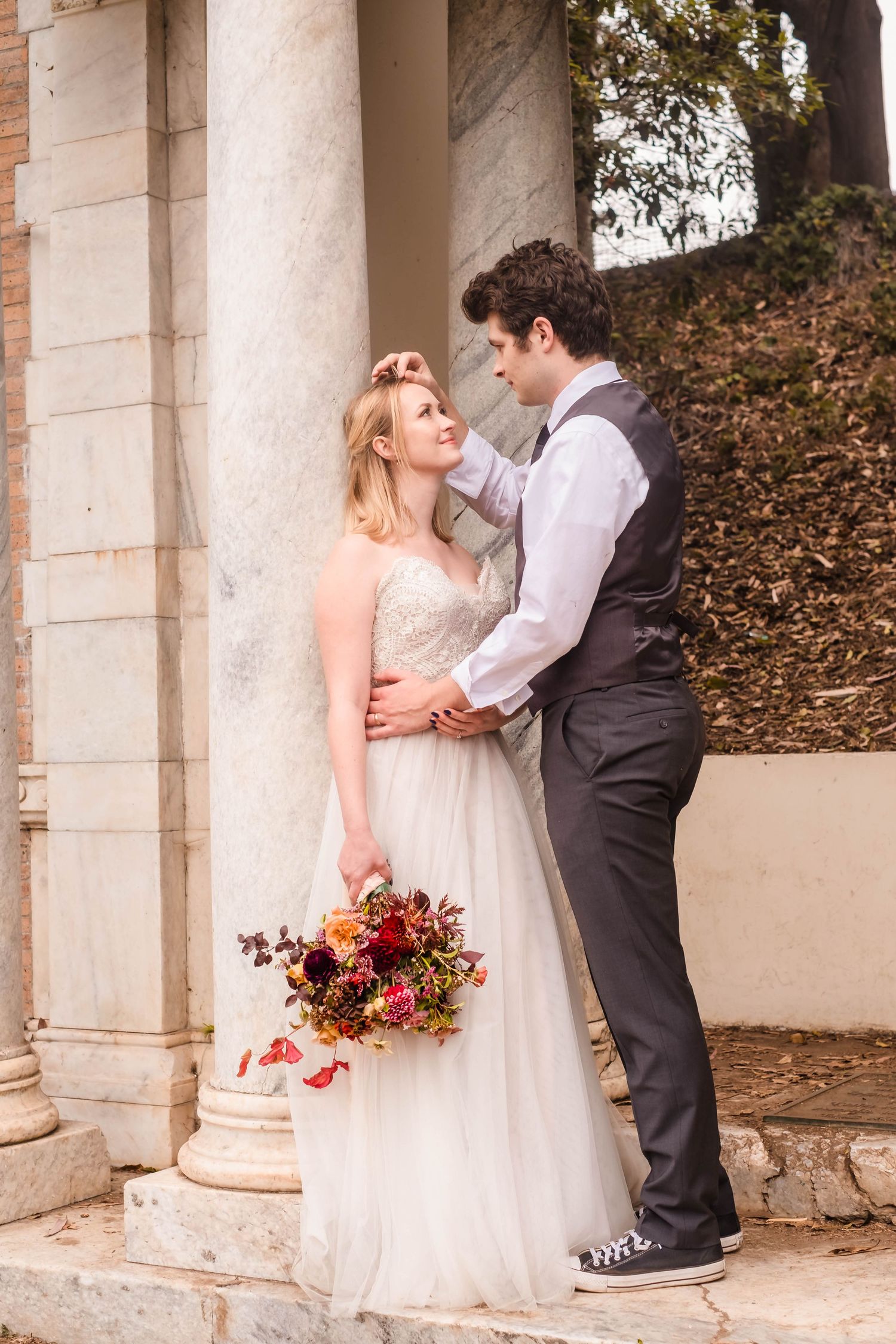 Sarah and Riley standing beneath the Portals of the Past arch during a Harry Potter–inspired photoshoot in Golden Gate Park.