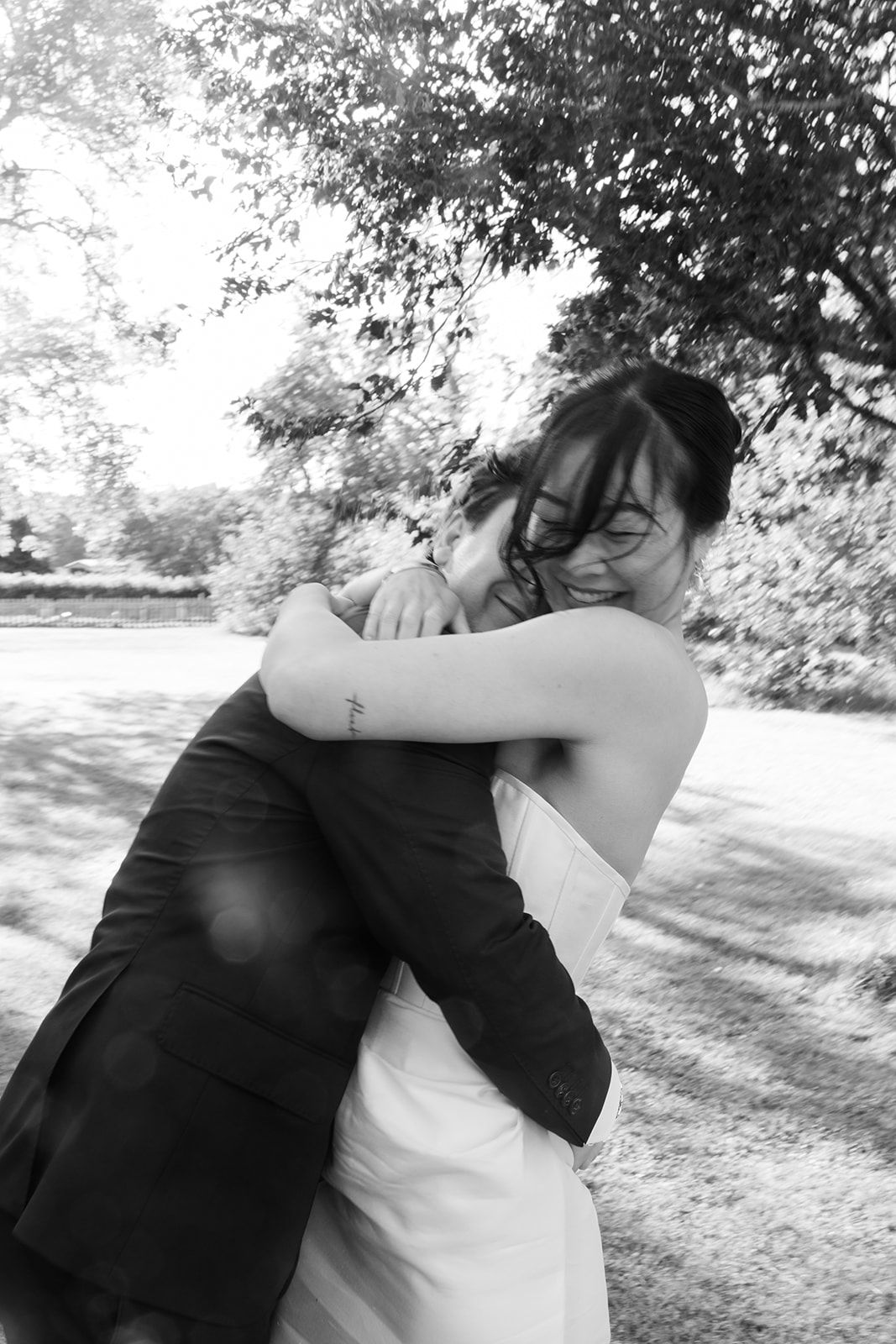 A romantic black and white photo sequence shows a couple embracing in a sunlit outdoor setting under trees.