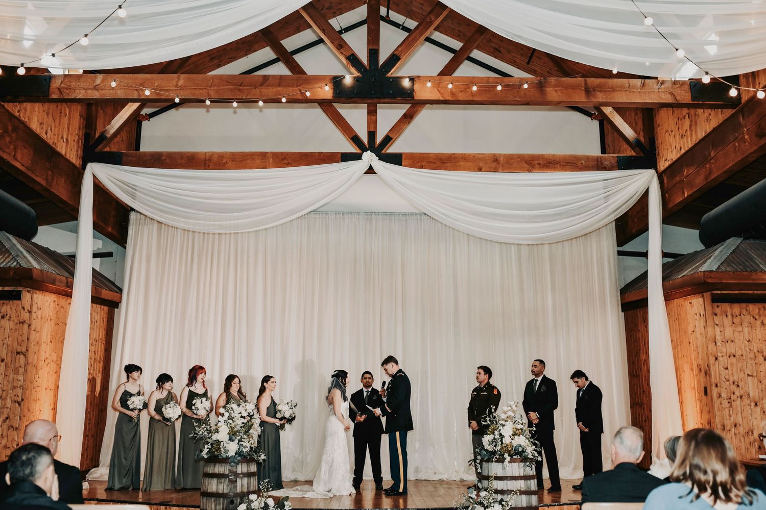 Wide-angle view of the Lucky Spur Ranch wedding ceremony with guests seated and sprawling ranch landscape.