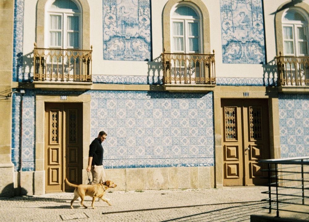 Traditional Portuguese building facade with blue azulejo tiles and arched windows.
