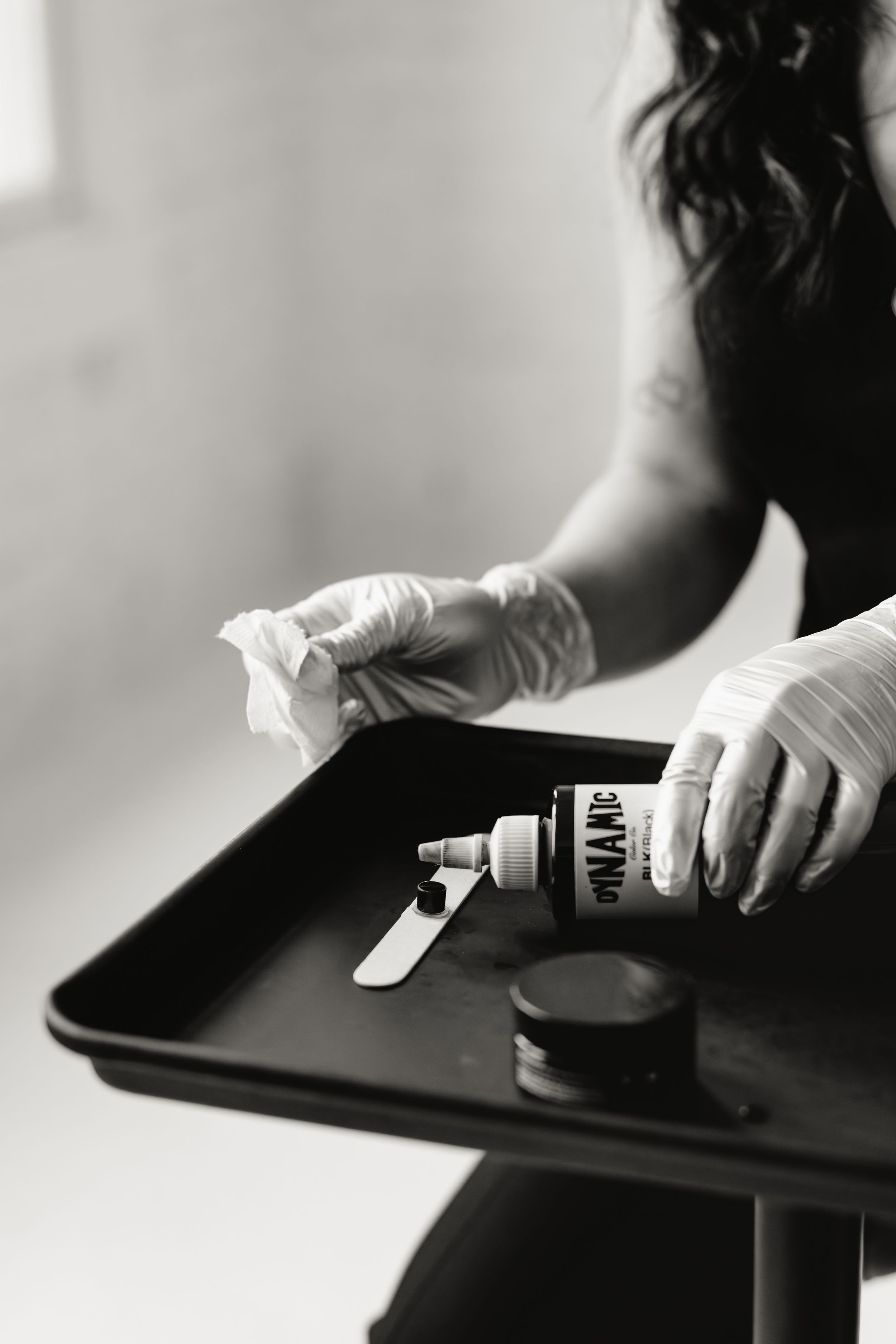 Close-up shots of hands preparing coffee on a dark surface with natural window lighting.