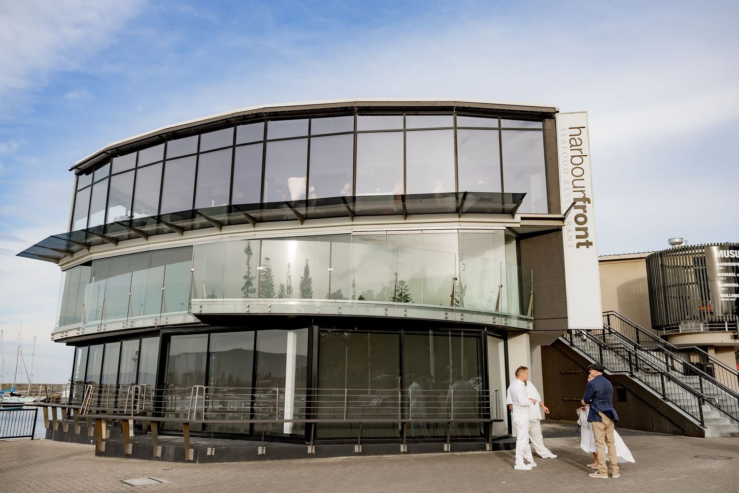 Modern glass and steel building facade with curved architectural features and clean minimalist design elements.