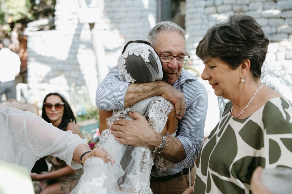 Emotional moment shared between wedding guests during outdoor celebration.