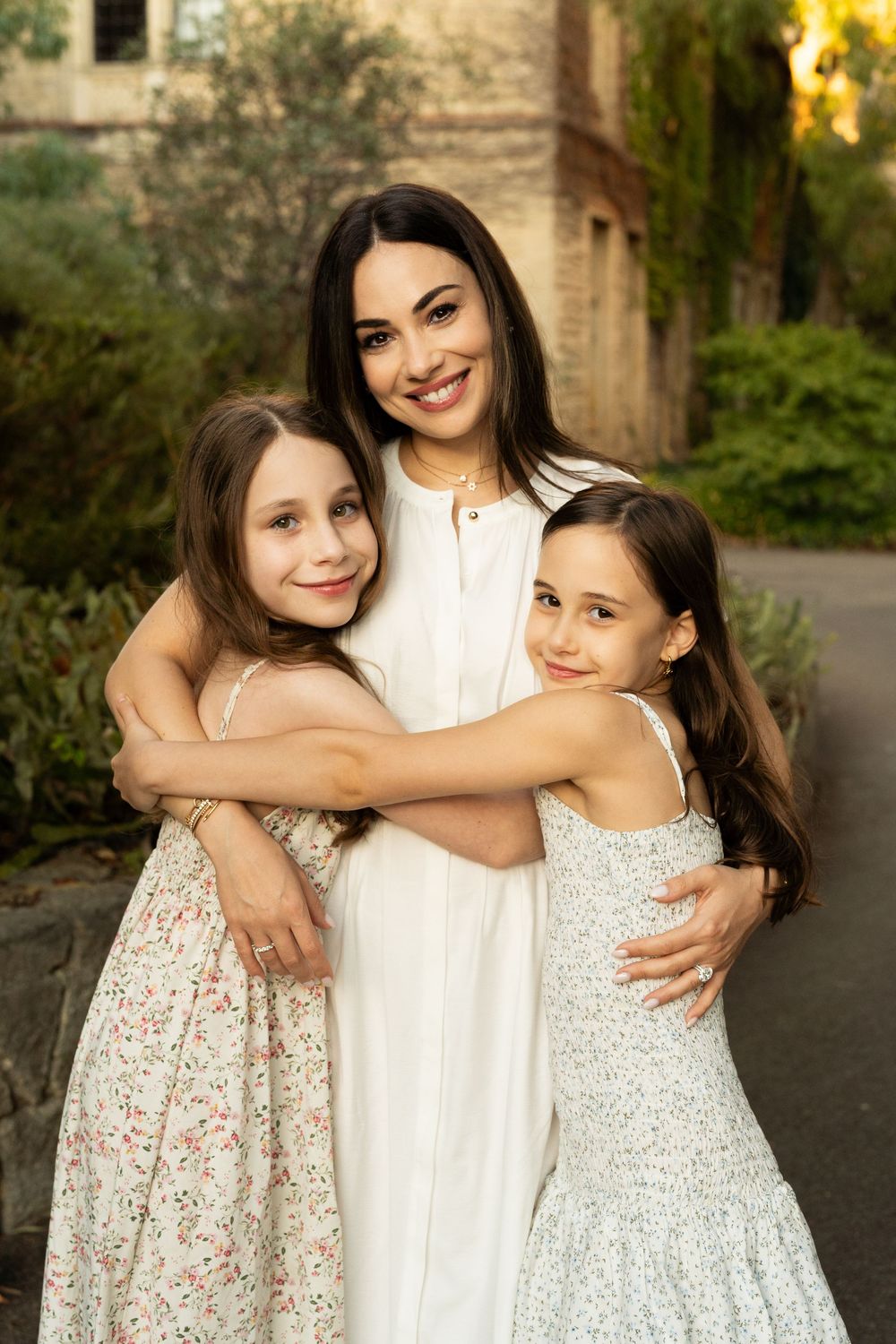 A mother with her two children in warm golden light at an outdoors Perth family photography session