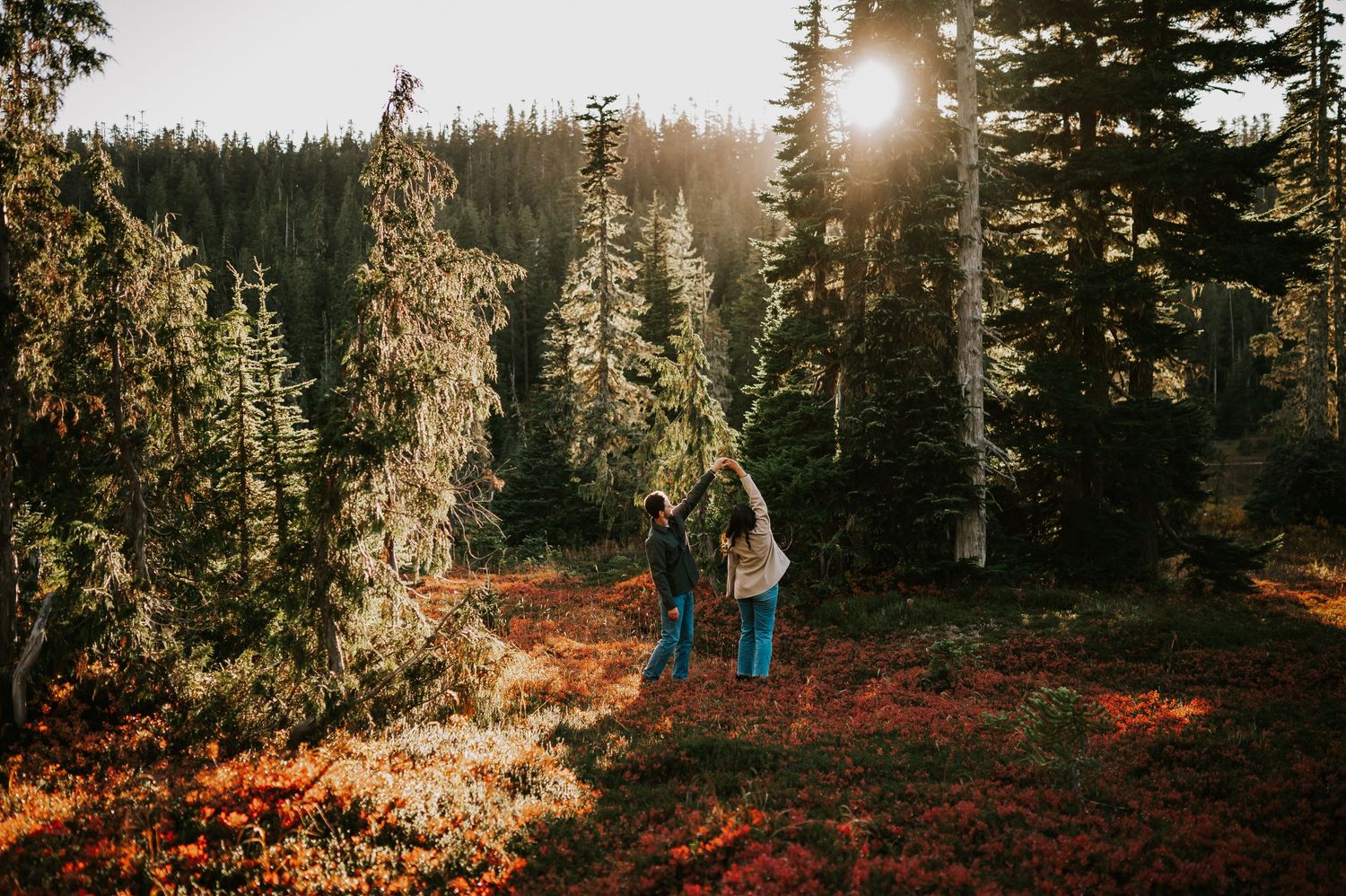 Engagement photographer of couple on Mt. Washington spinning in paradise meadows in fall autumn for couple photoshoot Vancouver Island