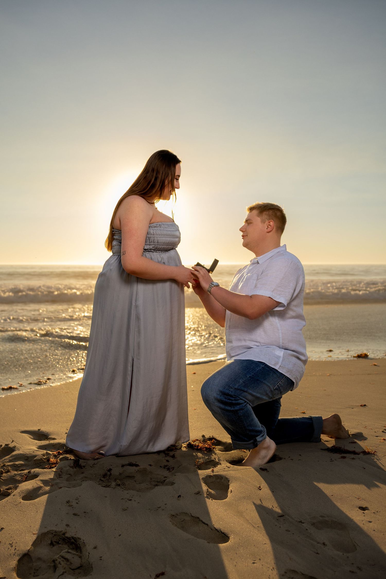 A romantic beach proposal sequence at sunset with two people on the sandy shore.