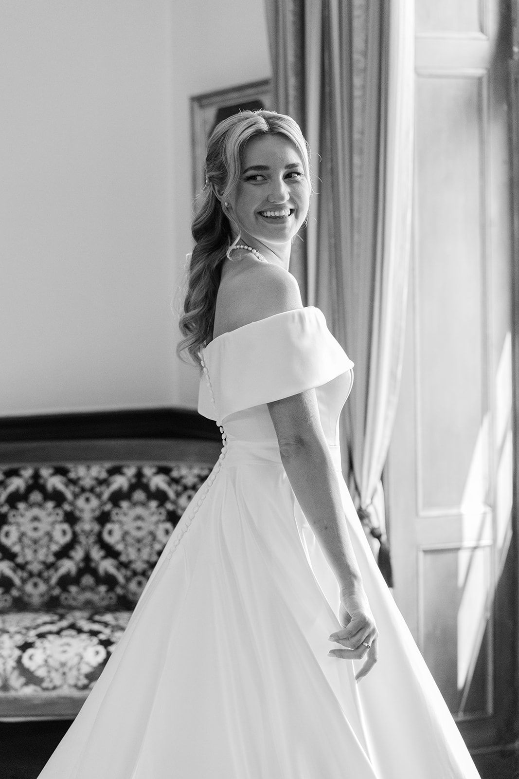 Black and white wedding photos show a bride in an elegant white gown with a dramatic bow detail.