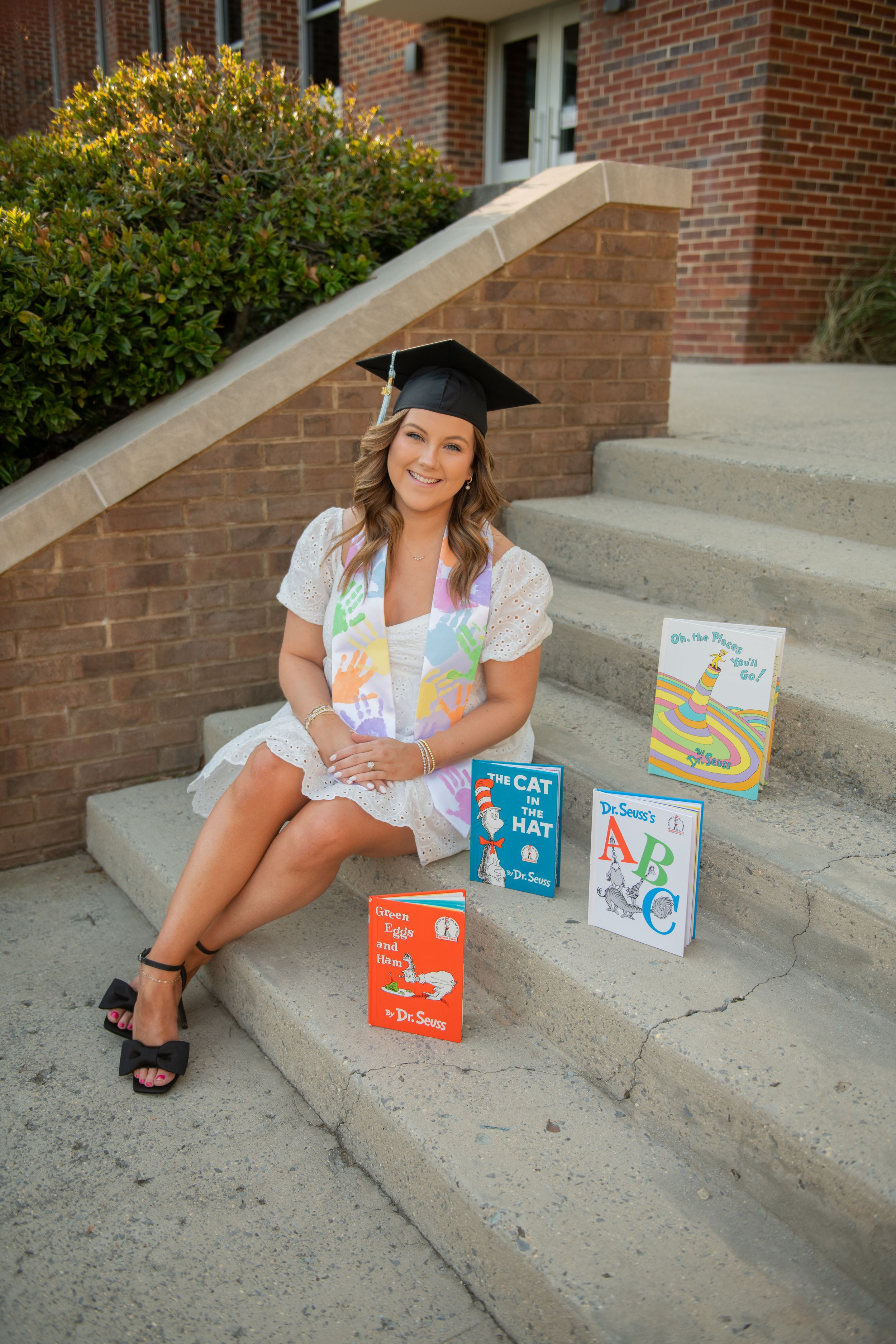A series of photos showing textbooks and study materials arranged on concrete steps with a brick background.