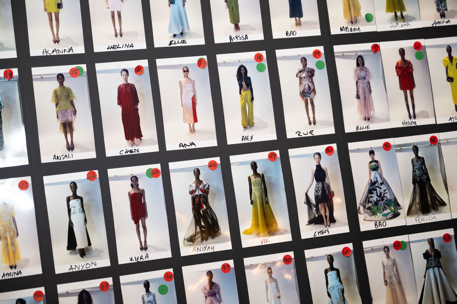 Fashion design board with lineup of clothing sketches and fabric swatches arranged in organized rows on display.