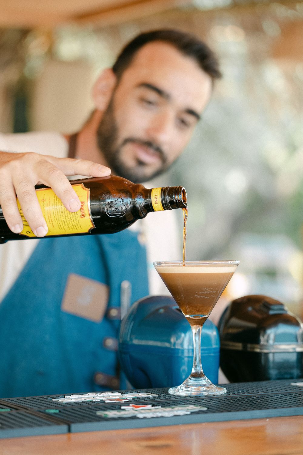 Casual moment of cocktail service captured in warm, candid style.